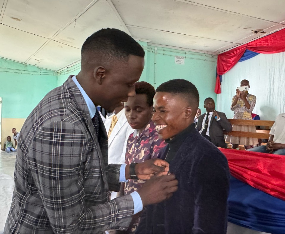 A moment of pride: Prosper Nemasasi, Mutare District UMYF representative, pins the UMYF badge on Calvin Mukaira’s jacket, symbolizing his commitment to the UMYF motto, ‘Christ Above All,’ during the full membership ceremony at Nyakunu UMC